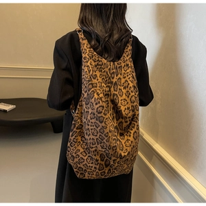 Detailed back view of a large leopard print tote bag styled as a minimalist hobo backpack