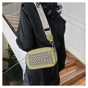 Lime green PU crossbody bag with silver studs and a wide geometric woven shoulder strap