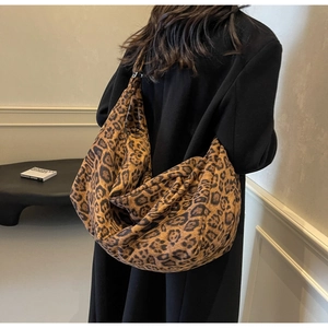 Macro detail of large hobo bag with leopard print textile and slouchy design