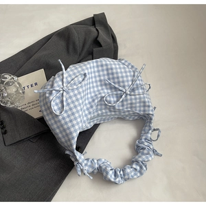 Blue and white checkered underarm bag with bow details and ruched bubble straps