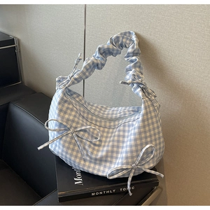 Blue and white plaid handbag with decorative bows and scrunchie handle for summer fashion