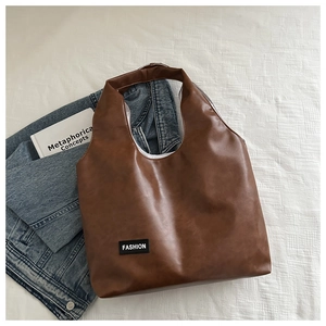 Brown PU leather minimalist hobo tote bag with a fashion label on a clean white background