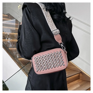 Pink PU camera bag with silver studs and wave jacquard wide strap on a model