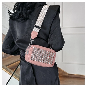 Pink PU leather crossbody bag with silver studs and geometric pattern woven strap
