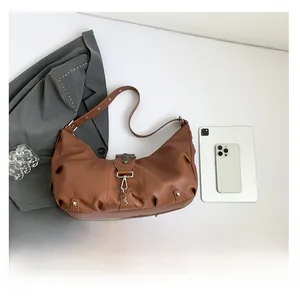 Détails d'un sac cabas marron vintage avec boucles argentées et garnitures en métal