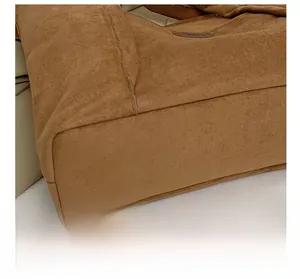 Close-up of precision stitching on a brown suede shoulder bag with retro texture details
