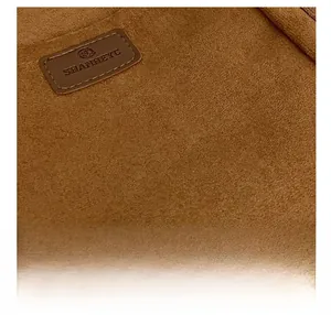 Macro shot of brown suede texture and precise stitching on the retro shoulder bag