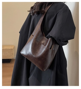 Detailed back view of a dark brown vintage PU leather shoulder bag for daily commuting