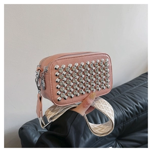 Pink PU leather crossbody bag with silver studs and woven strap in a modern square design