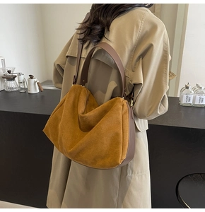 Detailed view of the ginger yellow suede hobo bag with dark brown leather strap shoulder bag