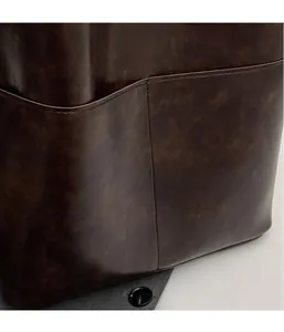 Close-up of dark brown PU leather side pocket with neat stitching and vintage texture