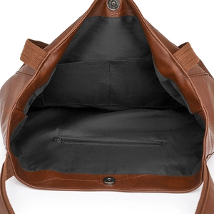 Interior view of brown PU leather tote bag with fabric lining, zipper pocket and magnetic snap