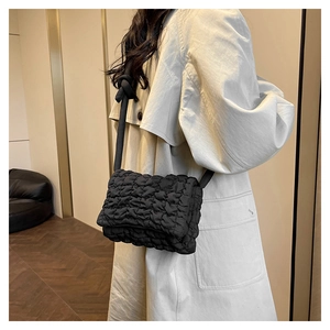 Schwarze gesteppte Nylon-Schultertasche mit Wolkentextur und Knotendetail am Gurt