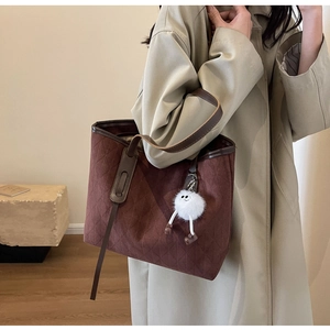 Detail view of brown quilted velvet tote bag with velvet texture and diamond stitching