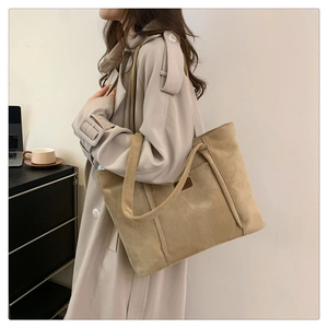 Detail of a large corduroy tote bag in earth tones, perfect for office or daily commute