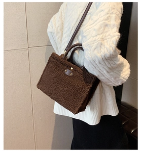 Detailed view of the soft brown plush faux fur tote bag with a vintage leather patch detail