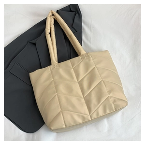 Chic beige quilted nylon tote bag with V-shaped stitching and padded long handles