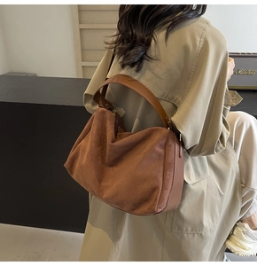 Detailed view of brown suede hobo bag texture and leather strap for women