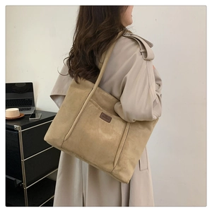 Detail of khaki corduroy tote bag showing large capacity and stylish side-view shoulder fit