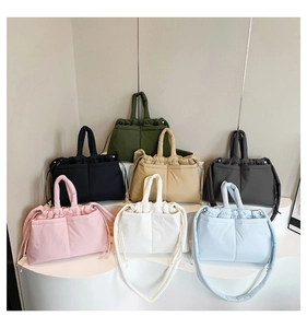Detailed display of colorful quilted puffer bags with drawstrings and dual front pockets
