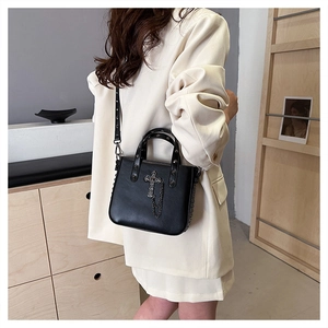 Chic black PU leather crossbody bag with silver cross charm and rivet detailing