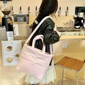 Vista dettagliata della borsa tote rosa trapuntata con texture a nuvola e manici