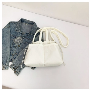Chic white puffer shoulder bag with drawstring closure and quilted fabric design