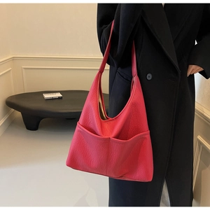 Close-up of vibrant magenta PU leather tote bag with stylish textured grain finish