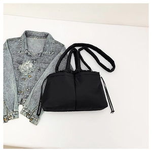 Fashionable black quilted puffer shoulder bag with drawstring closure for women