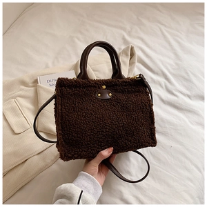 Deep brown plush shoulder bag with high-density faux fur and leather straps for autumn fashion