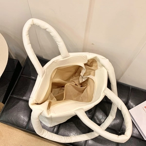 Vista dettagliata dell'interno della borsa trapuntata con ampio scomparto e tasca dorata