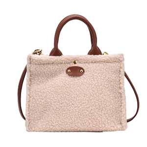 Chic autumn faux shearling shoulder bag with brown leather trim and golden rivets