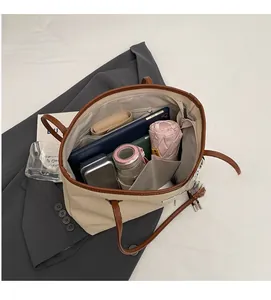 Top view of spacious beige canvas tote bag with brown leather trim showing large capacity