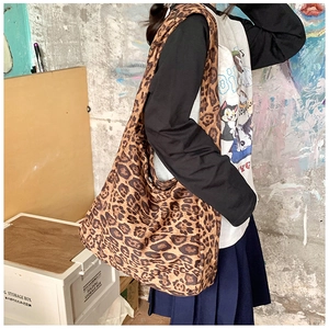Large leopard print canvas tote bag with wide strap shown on model for daily style