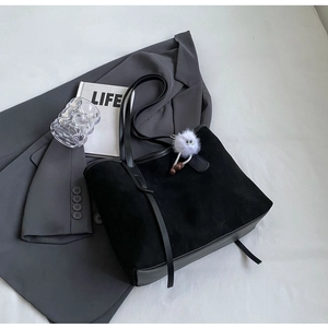 Minimalist black velvet tote bag with leather strap and cute white plush ball charm