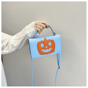 Detail shot of light blue PU leather handbag with orange pumpkin face patch for Halloween