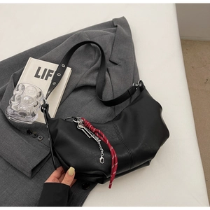 Minimalist black crescent crossbody PU leather handbag with silver chain and red cord charm
