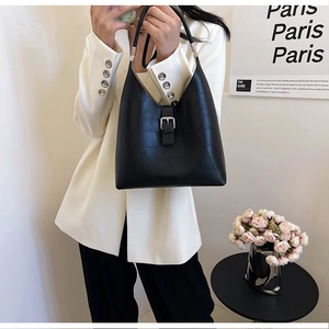 Détail d'un sac hobo en cuir PU noir avec textures géométriques et boucle argentée