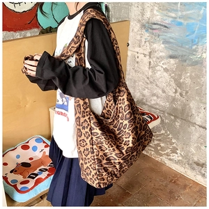 Close-up of a large leopard print canvas shoulder bag with vintage streetwear design