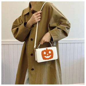 Detail of white PU leather crossbody bag with pumpkin print for Halloween styling