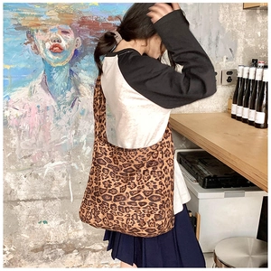 Close-up of leopard print canvas shoulder bag for women in a stylish interior setting