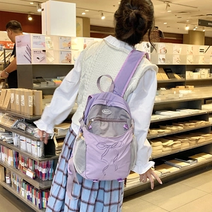 Detail eines hellvioletten Nylon-Rucksacks mit Kordelzug-Schleife und Netztasche