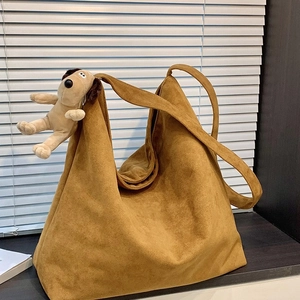 Chic warm brown suede tote bag with wide shoulder strap and Gromit plush charm