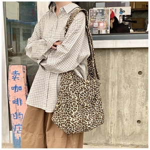 Outdoor street shot of a large leopard print canvas tote bag with comfortable shoulder strap