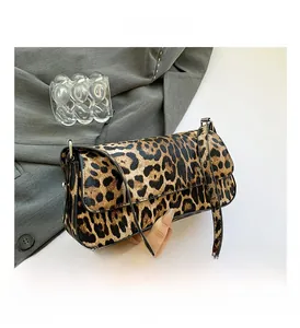 Close-up of leopard print PU shoulder bag featuring a flap closure and adjustable strap