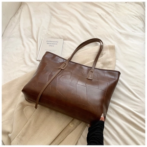 Fashionable brown PU leather tote bag with geometric patchwork design for autumn style