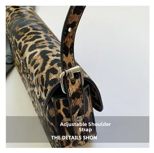 Close-up of adjustable silver buckle and leopard print texture on PU shoulder bag