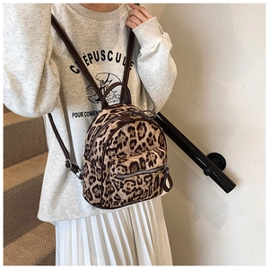 Primer plano detallado de una mini mochila de leopardo con correas marrones