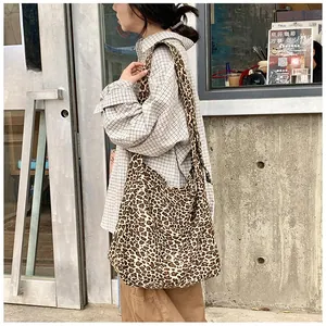 Detailed view of women casual leopard print canvas hobo bag in street style setting