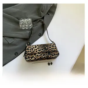 Close-up of leopard print shoulder bag with magnetic flap on white background